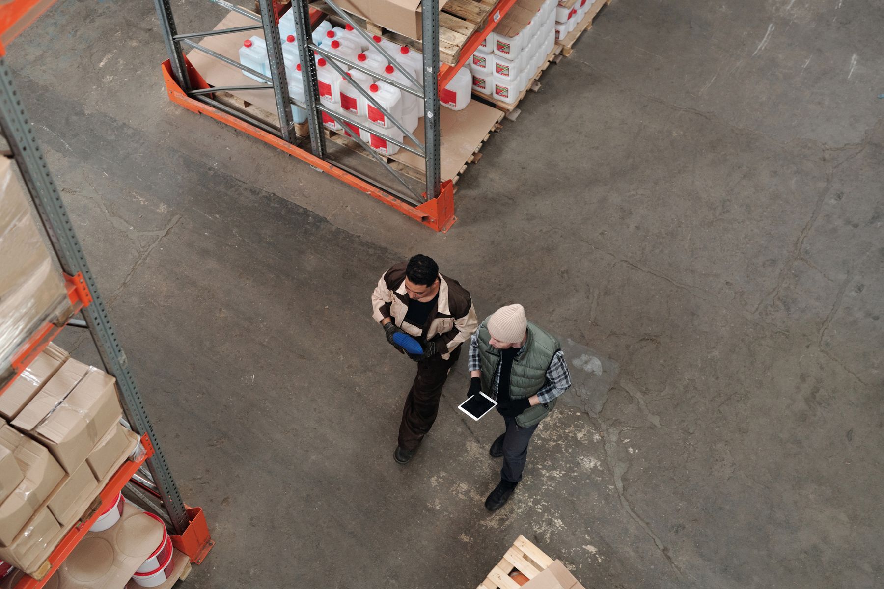 Warehouse colleagues coordinating work with a tablet